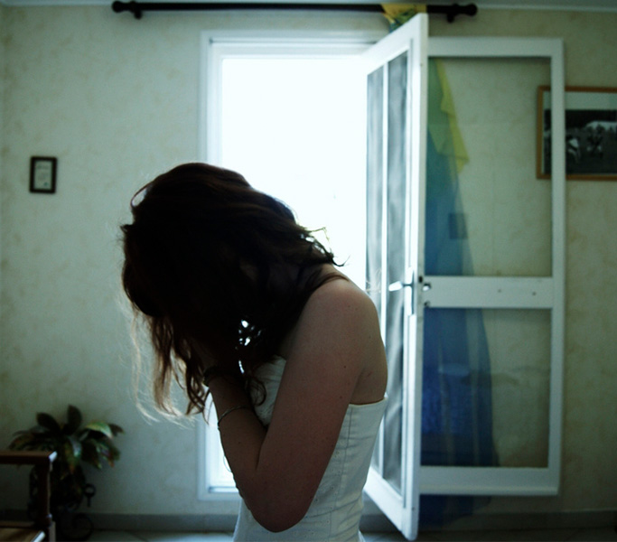 Woman with her face in her hands appearing to be crying